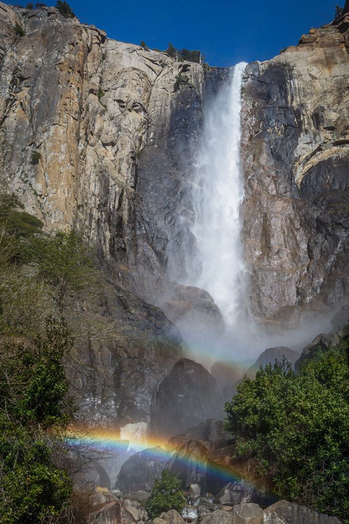 Photograph of Bridalveil Fall in Yosemite Valley with Rainbows taken on a late afternoon in springtime.